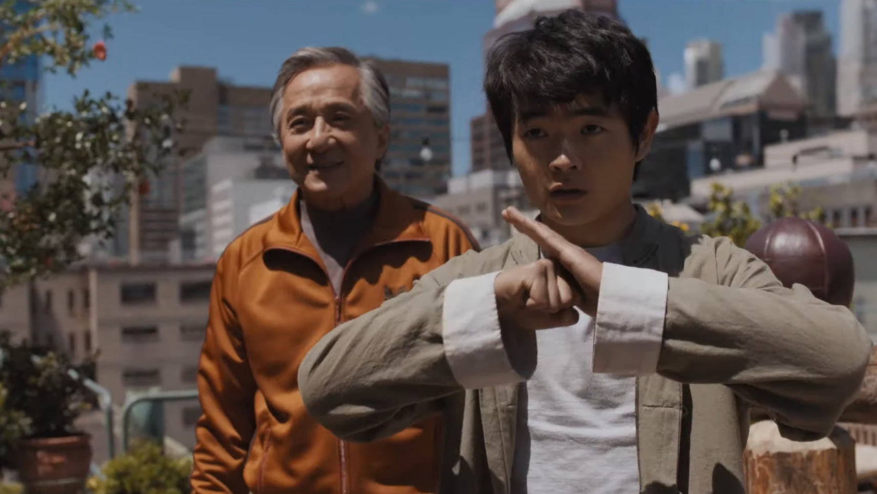 A still from Karate Kid: Legends showing a teen boy and Jackie Chan on a roof top in New York. - 1