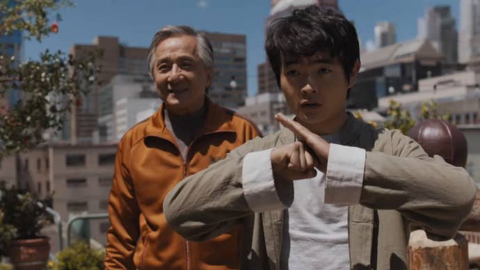 A still from Karate Kid: Legends showing a teen boy and Jackie Chan on a roof top in New York.