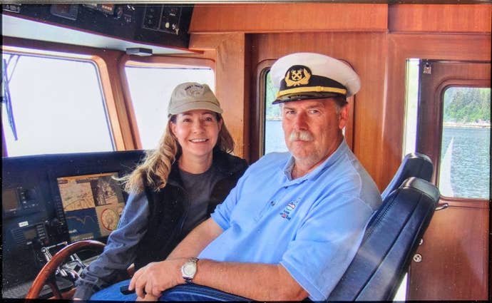 Ken and Roberta Williams inside a wooden cockpit of a boat. Ken is looking particularly fetching in his captain’s hat and moustache.