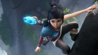 A young girl named Kena climbs along the side of a cliff in Kena: Bridge of Spirits