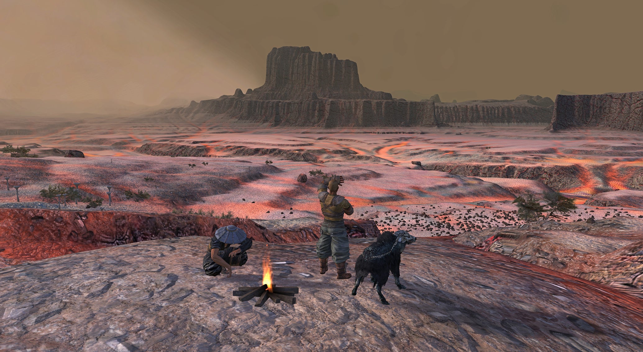 Two men and an alien goat gather round a campfire as they look out across a red, desert landscape in Kenshi - 1