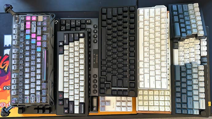 a pile of 10 keyboards