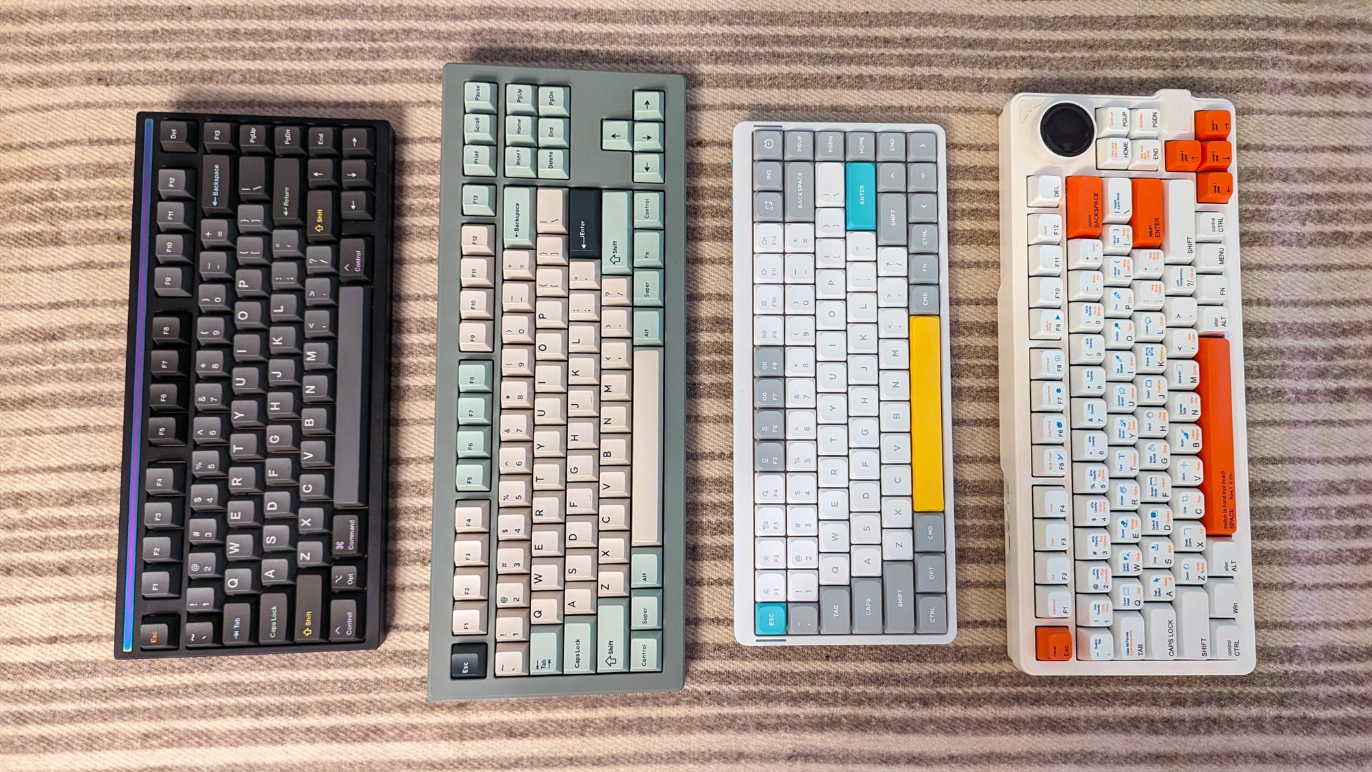four keyboards on a wool-topped table - from left to right the mode sonnet, drop cstm80, nuphy air75, gamakay lk75