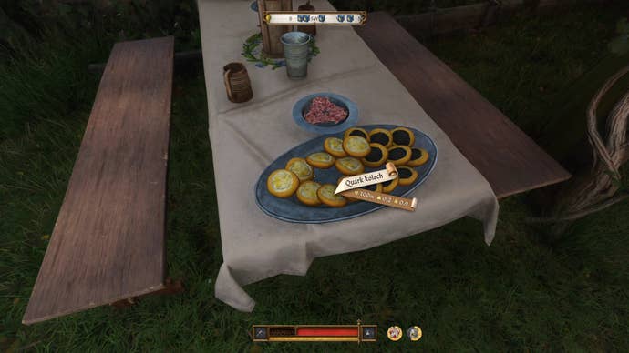 The player in Kingdom Come: Deliverance 2 looks towards a serving platter of food.
