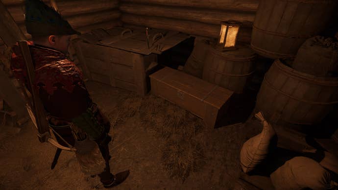 Henry stands in front of a locked chest in a barn in Kingdom Come: Deliverance 2.