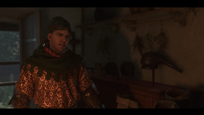 Henry speaking to the alchemist in Troskowitz while wearing a full fancy outfit in Kingdom Come Deliverance 2.