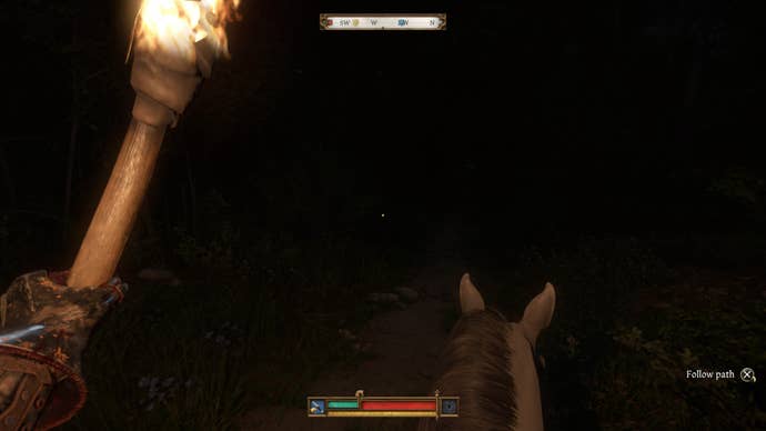 Henry holding a torch while riding a horse in Kingdom Come Deliverance 2.