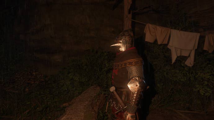 A knight in clean armour standing next to a washing line in Kingdom Come Deliverance 2.