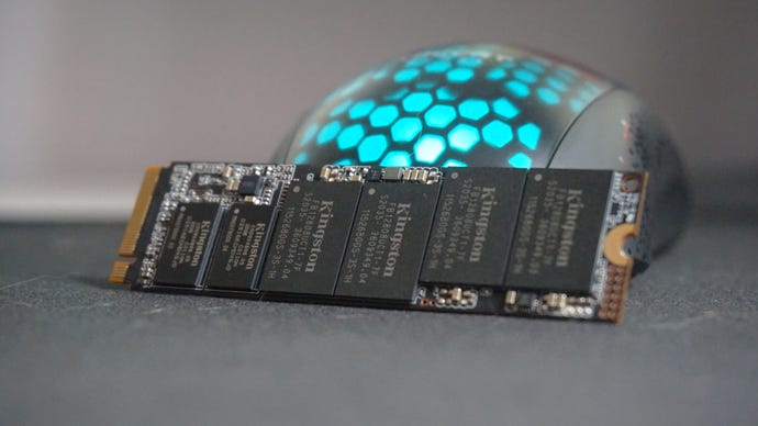 A photo of the Kingston KC2500 SSD in front of an RGB gaming mouse