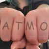 Outstretched fists displaying a mock-up knuckle tattoo: MEAT MODS