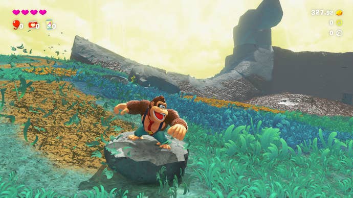 a screenshot of Donkey Kong Bananza, where a giant gorilla is stood on a rock in a clearing