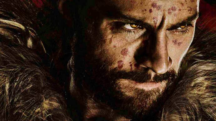 A close-up of Aaron Taylor-Johnson in a poster for Kraven the Hunter, he has a very serious expression on his face, which has numerous spots of blood across it.