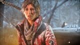 A battered and scratched up Lara Croft, with a makeshift bow and snow covered red jacket, in Rise of the Tomb Raider