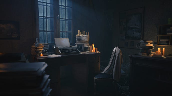 A dimly candle-lit room with a typewriter on a desk under the windows. It’s dusk outside and a nearby chair has a shawl or blanket draped over it. The room is very cluttered with books, papers, and pictures on the walls. An unlit oil lamp sits on the table.