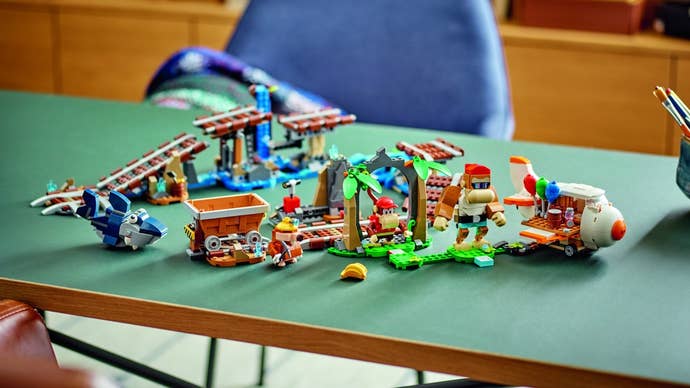 Lego’s Diddy Kong’s Mine Cart Ride set spread out on a table as a jumble of track pieces and parts.