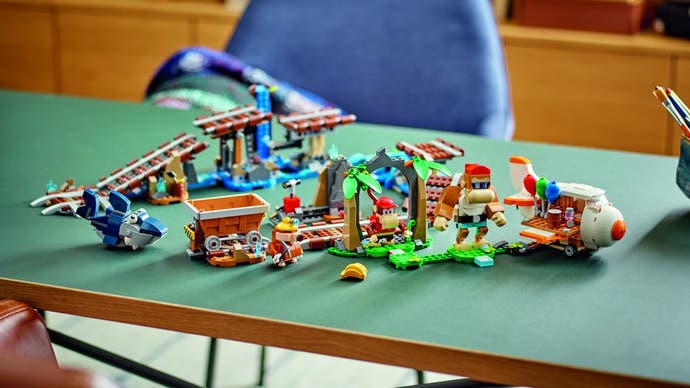 Lego's Diddy Kong's Mine Cart Ride set spread out on a table as a jumble of track pieces and parts.