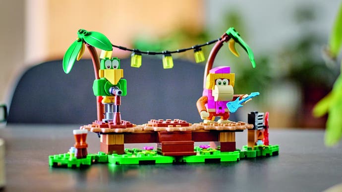 Lego's Dixie Kong's Jungle Jam set featuring a Lego Dixie on a tropical wooden stage with lanterns hanging overhead.