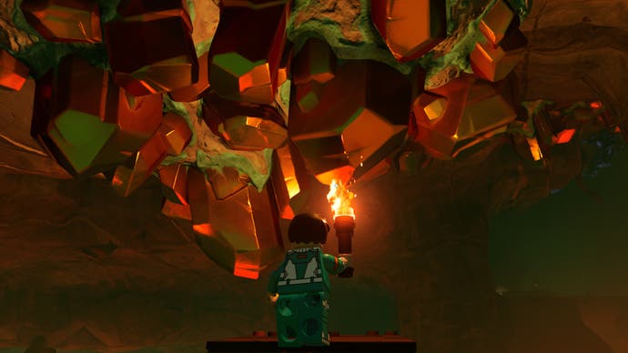 lego fortnite character facing copper deposit in lava cave with flame torch