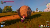 Power Chord rolling a boulder up a grassy hill in LEGO Fortnite