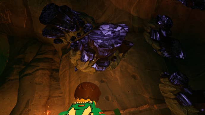 lego fortnite player looking up at obsidian in lava cave