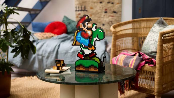 A Lego sprite of Mario and Yoshi sits on a glass-topped table in the middle of a nice loft bedroom.