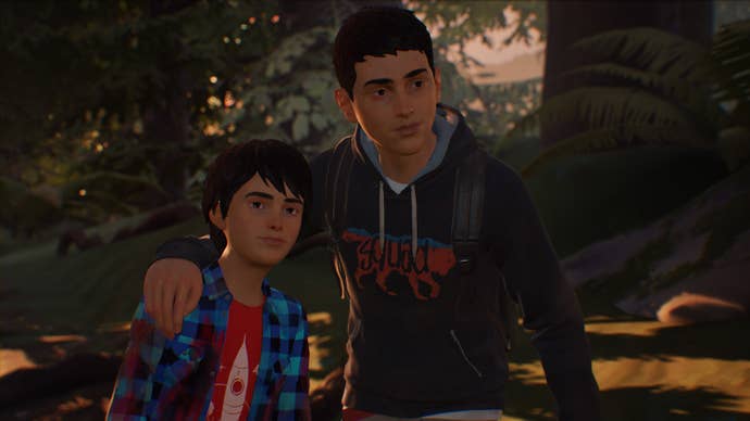 The protagonists of Life Is Strange 2 in a close-up against a forest background. Older brother Sean has his arm around younger brother Daniel, and both are smiling slightly.