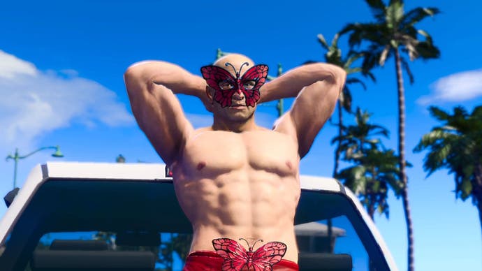 A shirtless person is posingon the back of a truck wearing a red speedo with a butterfly mask on. (EMBARGO)