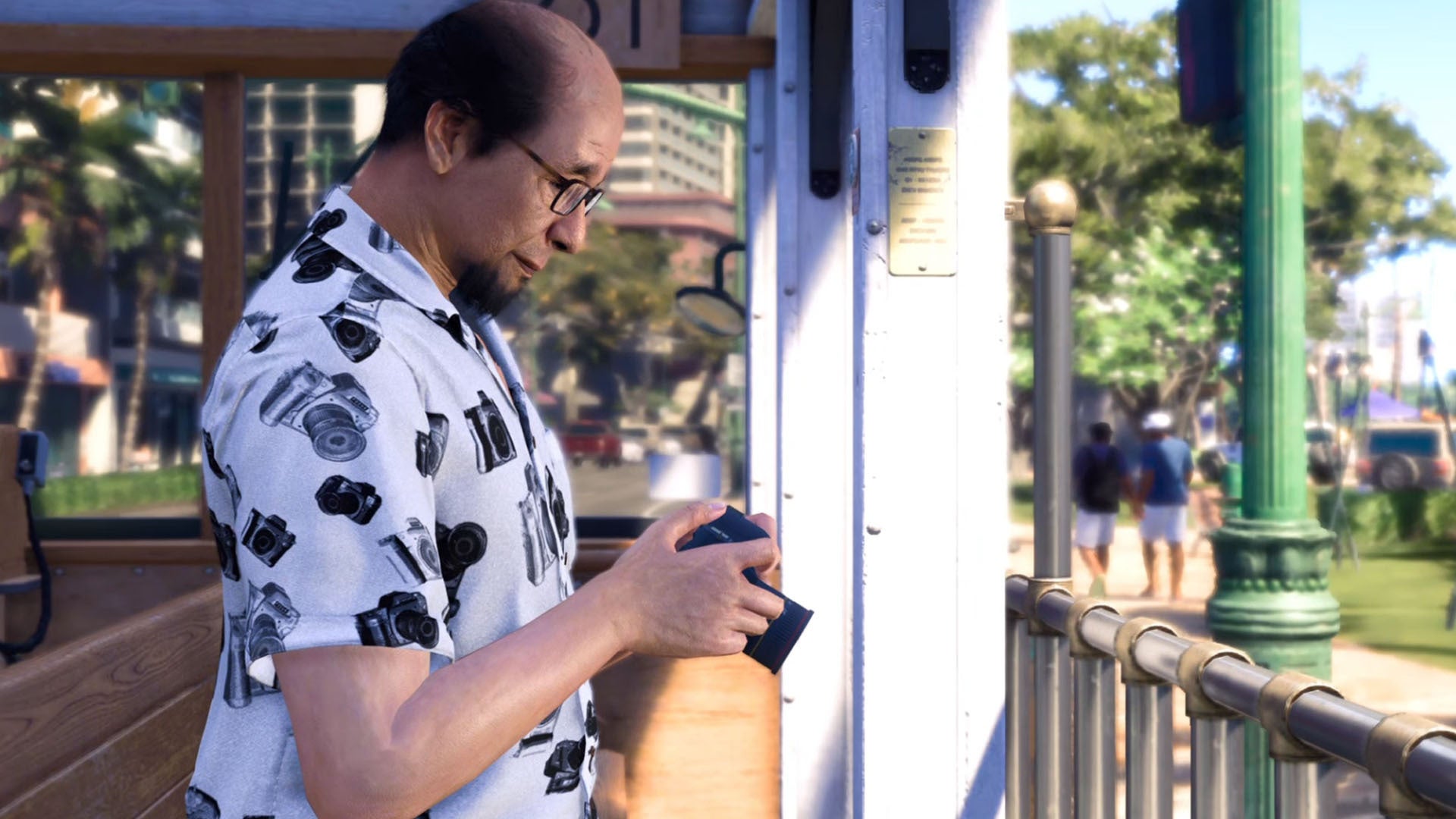 A person called George Kuroki holding a camera while on a Trolley in Like a Dragon Infinite Wealth.