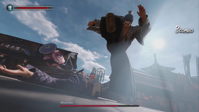 Ryoma (Kiryu) raises his foot to stamp on the head of a thug in Like A Dragon: Ishin.