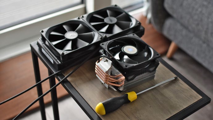 An NZXT Kraken X62 on a table next to a Cooler Master Hyper 212 Evo V2.