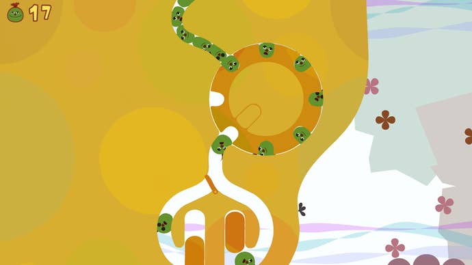 A screenshot from Loco Roco: Remastered which shows green blobs make their way around a conveyor belt puzzle.