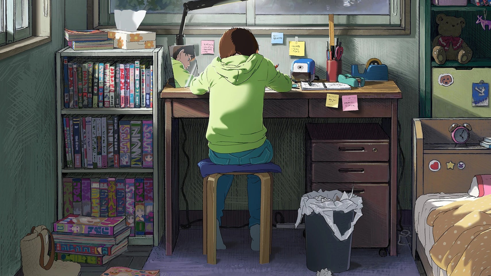 A girl in a green hoodie sat at her desk drawing manga. - 1