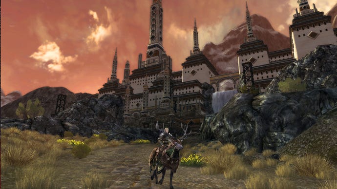An elf rides a stag away from a beautiful settlement in Lord Of The Rings Online.