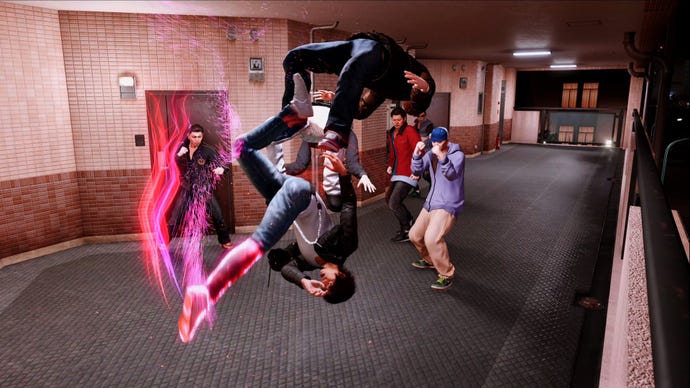 Yagami fli-kicks a thug in Lost Judgment as a pack of enemies watches on.