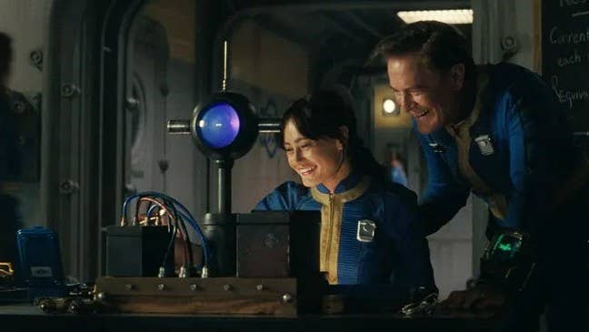Lucy and her father in Amazon’s Fallout TV series. They are inside Vault 33 and both look happy and healthy.