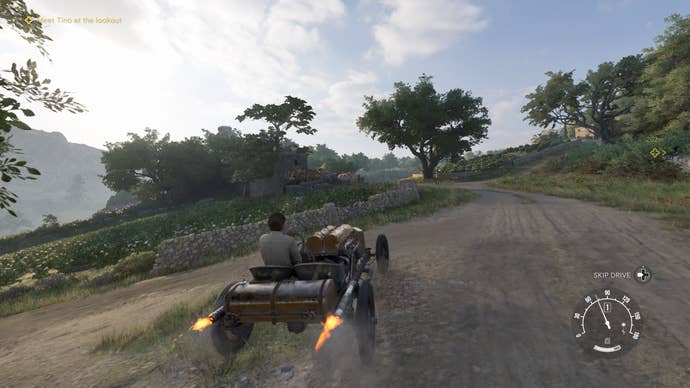 A Mafia: The Old Country Screenshot. Enzo drives a car through the summery countryside.
