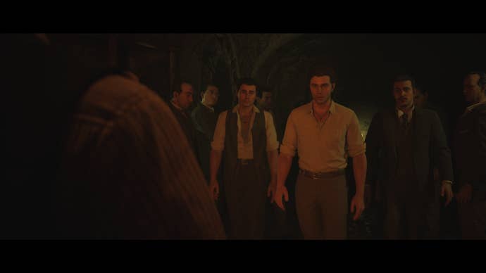 A Mafia: The Old Country Screenshot. Enzo is gathered with a gang of his Mafiosi associates in a darkened room.