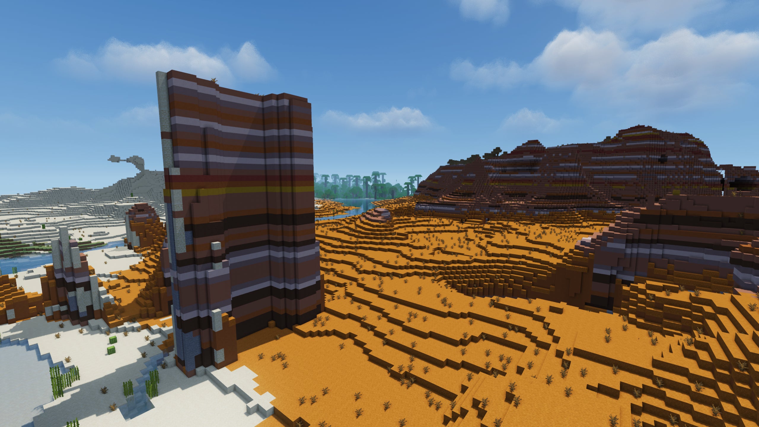 A mesa biome in Minecraft, with a tall square-like rock on the left-hand side showcasing MakeUp Shaders.