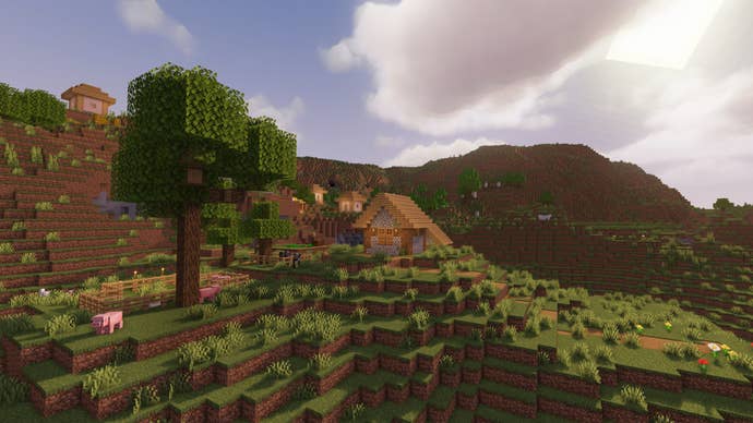 A Minecraft extreme hills landscape with a tree in the foreground and a village in the background showcasing MakeUp Shaders.