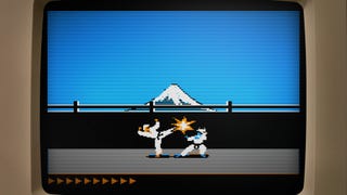 A close-up of an old computer monitor showing a sequence from 1984 classic martial arts game Karateka, with two fighters battling in front of a distant snow-capped mountain.
