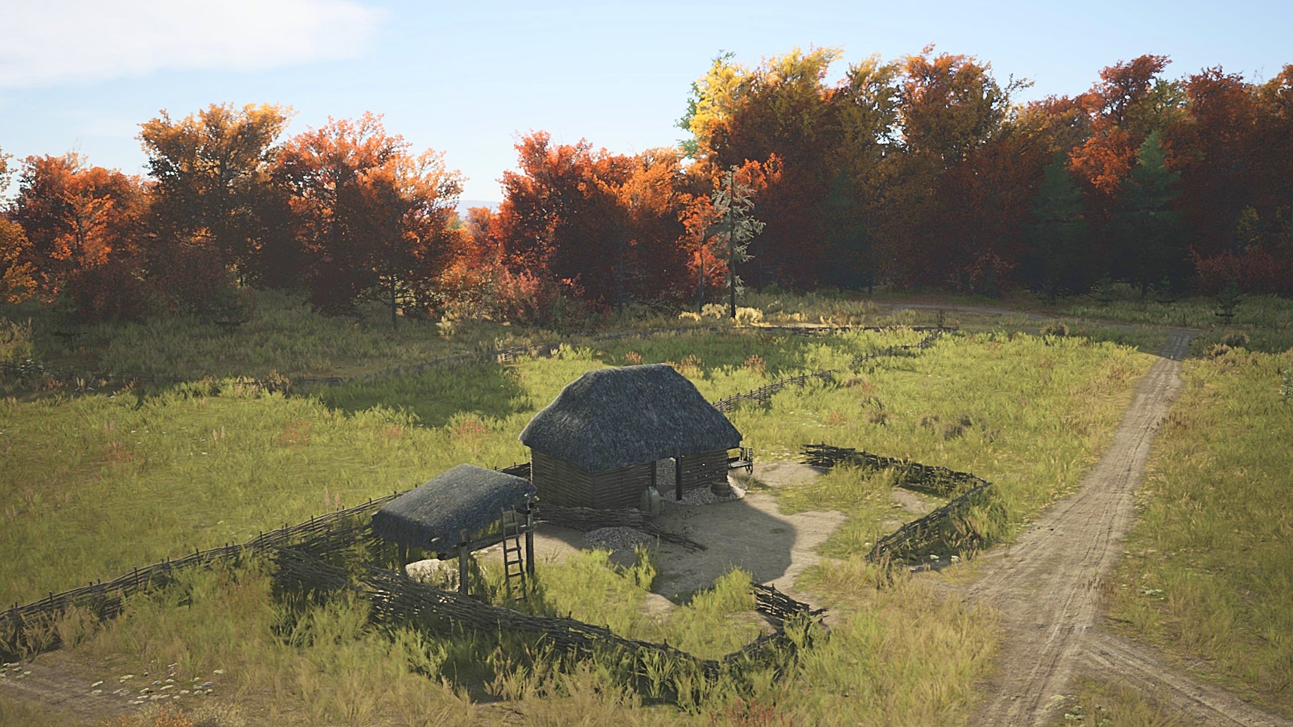 A Manor Lords farm sitting on the edge of an autumnal forest under bright afternoon sunshine