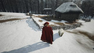 A man in a red cape and hat stands in front of a sheep farm in Manor Lords.