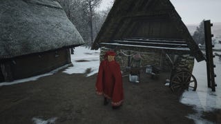 A man in a red cape stands in front of a smithy in Manor Lords