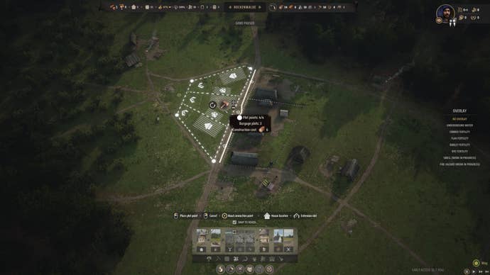 The player places down a section of Burgage Plots in Manor Lords.