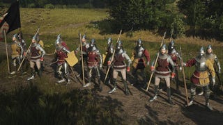 Screenshot of Manor Lords showing a line of pike carrying soldiers in a grassy field