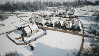 A village in Manor Lords blanketed by snow in winter.