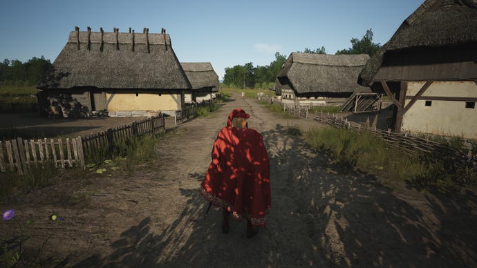 The player in Manor Lords walks between two rows of Burgage Plots in third-person as their Lord.
