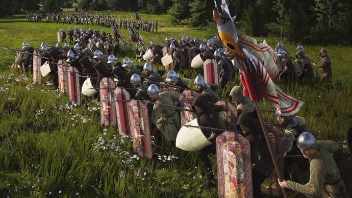 A row of soldiers stand with their spears and shields raised in Manor Lords.