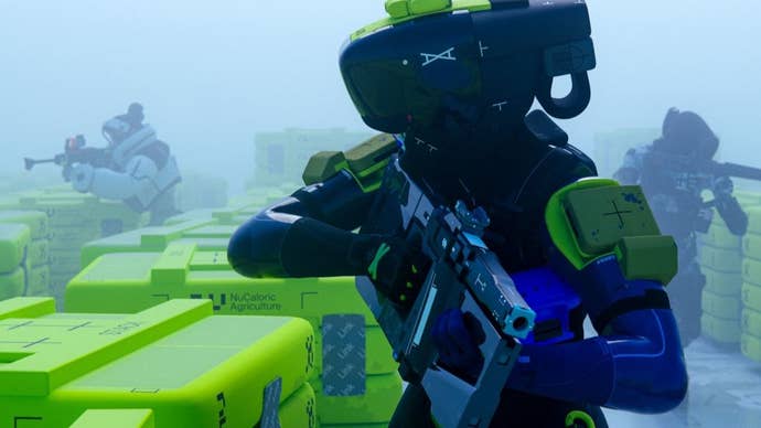 A heavily armoured soldier in a large cybernetic helmet walks towards the camera, with two fellow troops behind them.