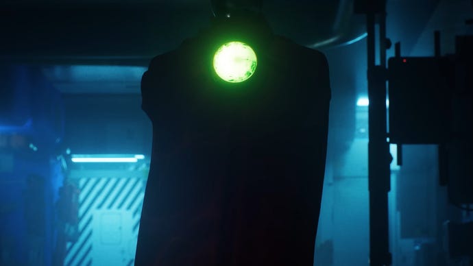 The silhouette of a Compiler in the Marathon trailer, their green glowing light in the centre of their chest visible in the dark.